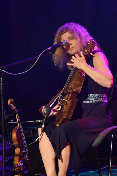 Kobieta gra na skrzypcach siedząc