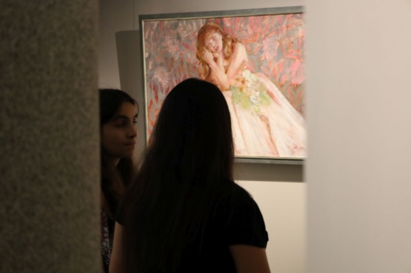 Dwie kobiety patrzą na obraz, zdjęcia zrobione z tyłu